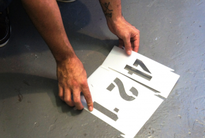 parking stencil held over floor