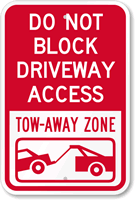 A Driveway Sign: Do Not Block Driveway Access - Tow Away Zone