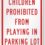 Children prohibited from playing parking lot sign