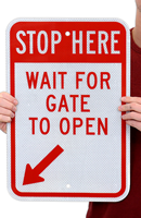 STOP Here Wait For Gate To Open sign